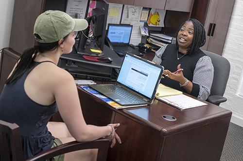 a student talks with a career counselor at her desk